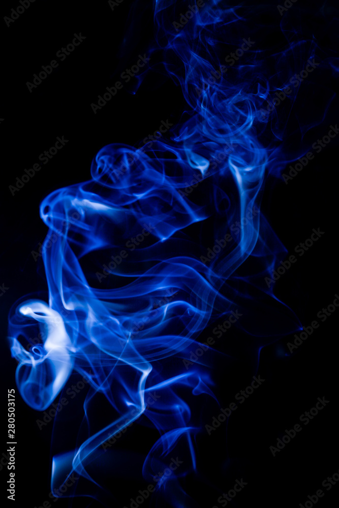 Fototapeta premium Blue toxic fumes movement on a black background.