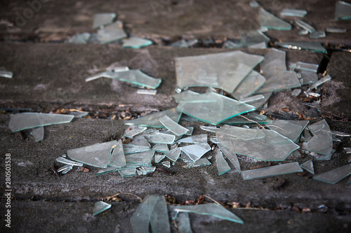 shards of broken glass on the old wooden floor