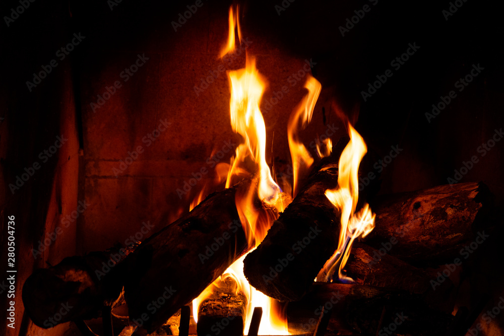 Fireplace detail with tall fire flames. Fireplace detail with tall fire flames.