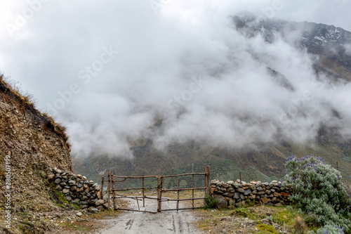 Curved mountain road in misty mountains, Abra Mariano Llamoja, pass between Yanama and Totora, The Choquequirao trek, Peru photo