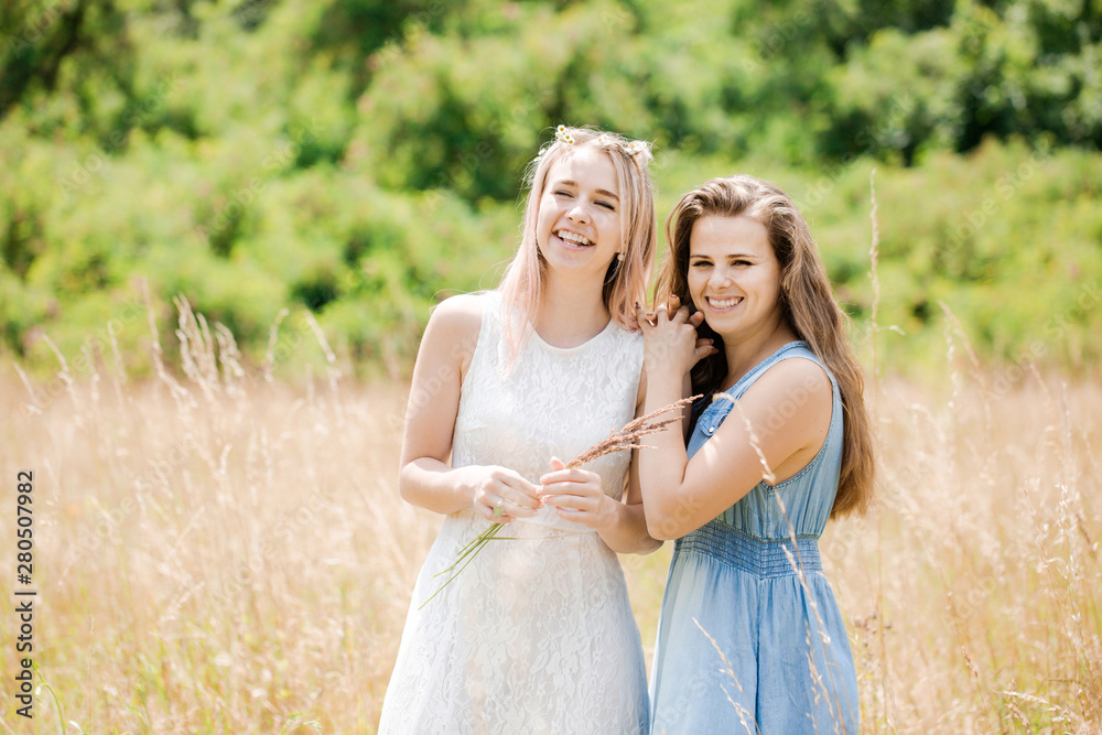 Fototapeta premium Two beautiful cheerful girls