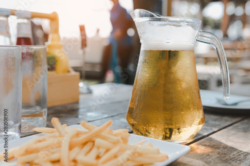 CHONBURI, THAILAND - April 21, 2018: A pitcher of Singha beer with a glass of beer on the table. photo