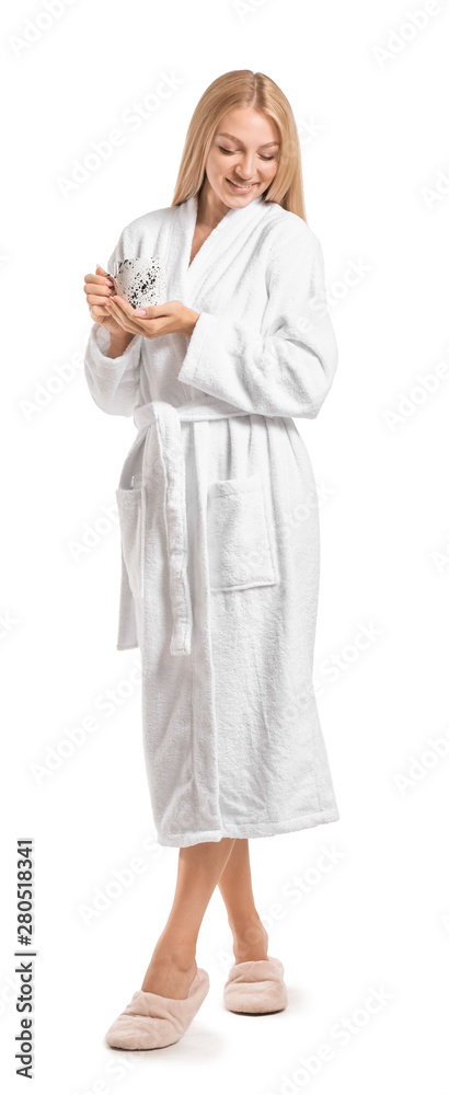 Beautiful young woman in bathrobe drinking coffee on white background Beautiful young woman in bathrobe drinking coffee on white background