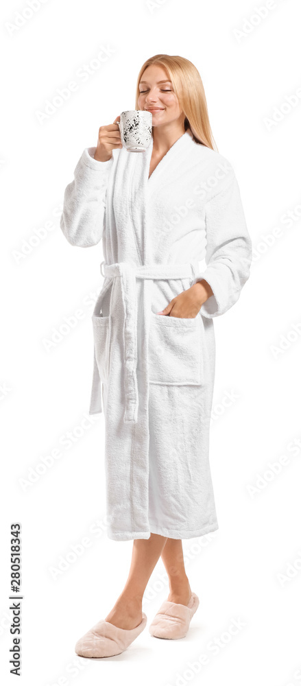 Beautiful young woman in bathrobe drinking coffee on white background Beautiful young woman in bathrobe drinking coffee on white background