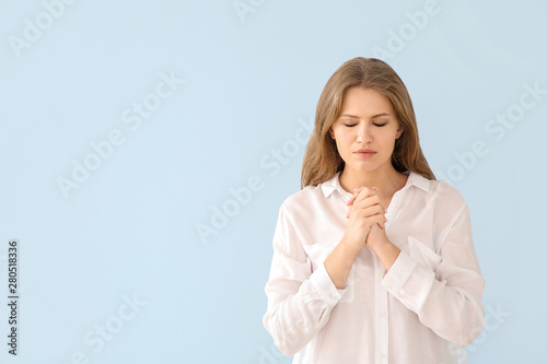 Religious young woman prayi...