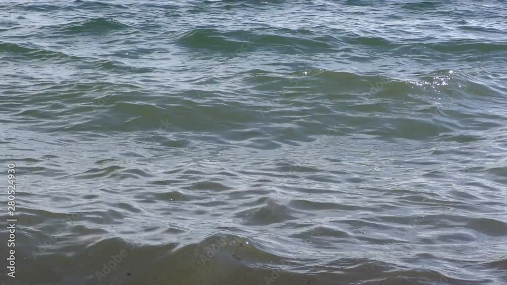 Water surface with waves and sun highlights. Water surface with waves and sun highlights.
