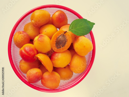 Fresh bright orange appricotes on white. Top view  close up.
