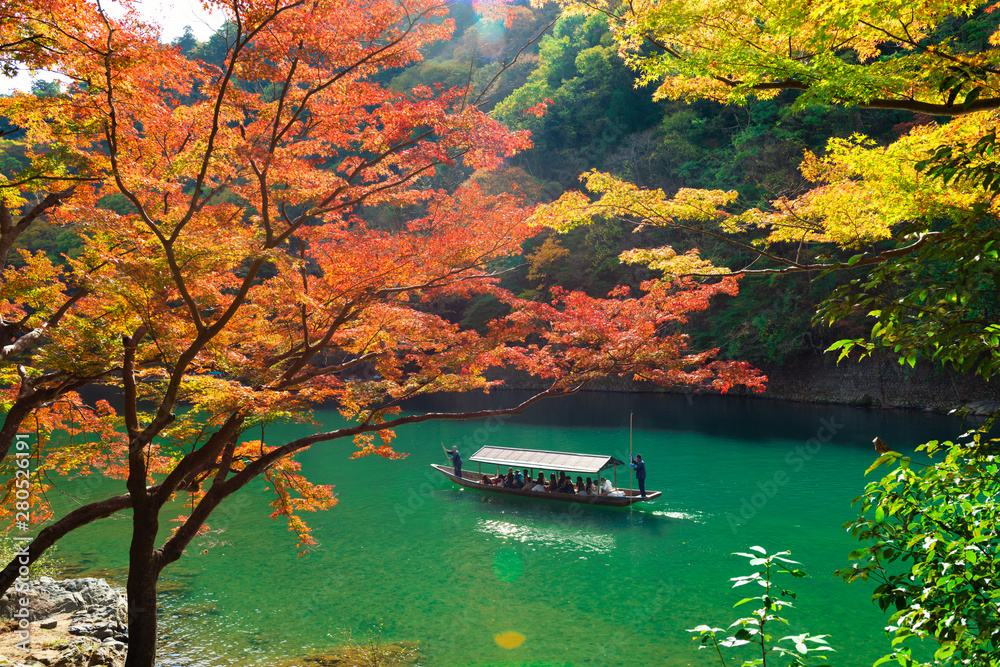 beautiful scene with tourist boat and Hozugawa river in Arashiyama park in autumn season, Kyoto, Japan beautiful scene with tourist boat and Hozugawa river in Arashiyama park in autumn season, Kyoto, Japan