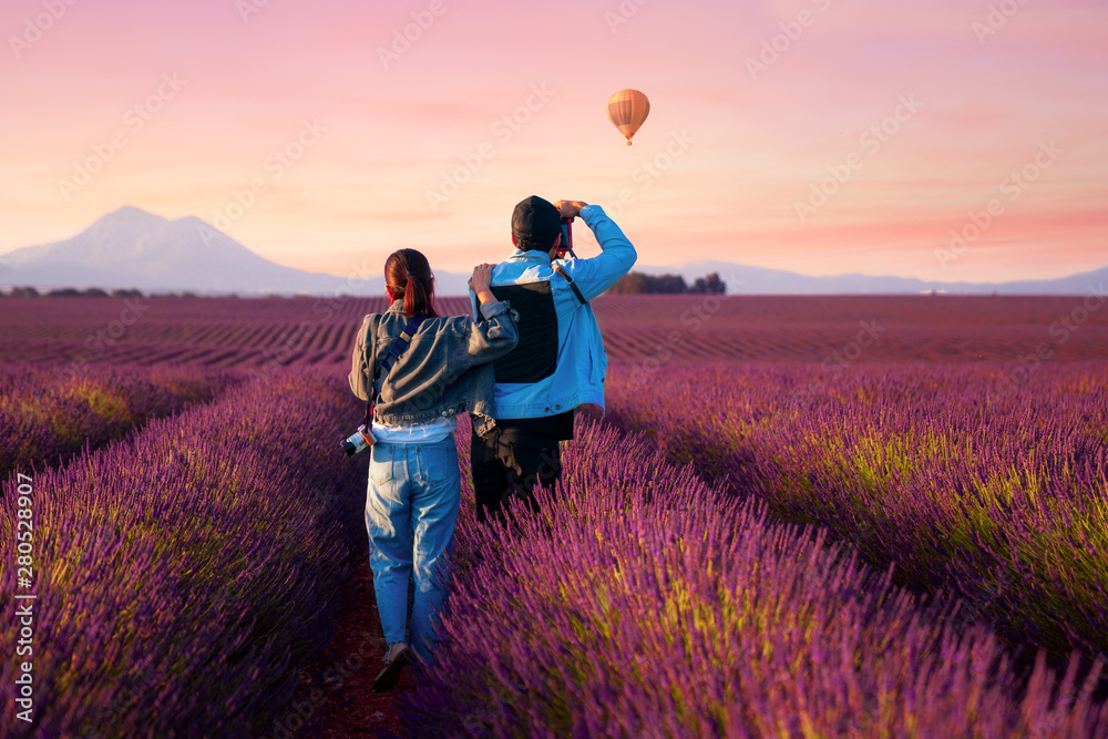 Asian couple travel in lavender field - obrazy, fototapety, plakaty 