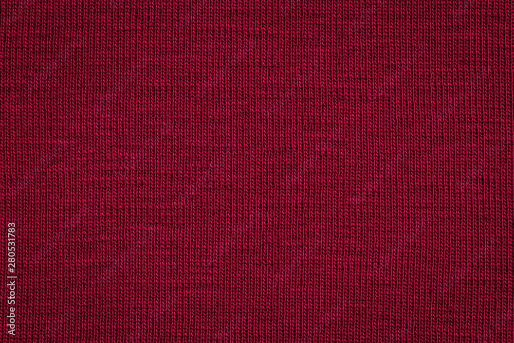 Fototapeta premium Texture of real dark burgundy knitwear, textile background. Dark red knitted background