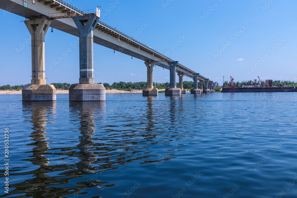View on the famous dancing bridge in Volgograd from the water of Volga river in the hot clear sunny summer day