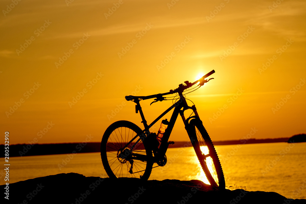 bike beside water with sunset. Active Lifestyle Concept. bike beside water with sunset. Active Lifestyle Concept.
