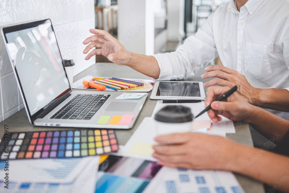 Teamwork of young creative designers working on project together and ...