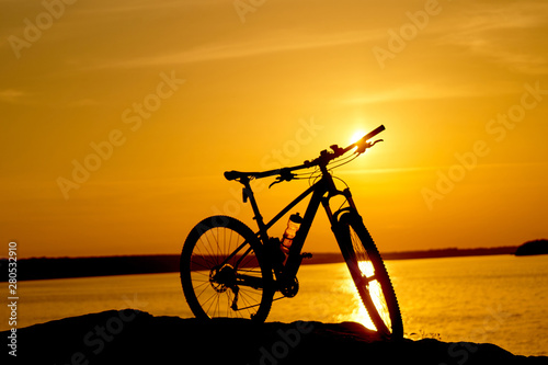 bike beside water with sunset. Active Lifestyle Concept.