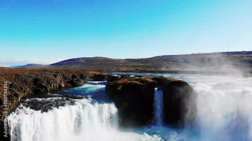 Godafoss in perfect daylight conditions during the summer. Aerial moving forward toward falls, panning down over falls as drone moves over it. Godafoss in perfect daylight conditions during the summer. Aerial moving forward toward falls, panning down over falls as drone moves over it.