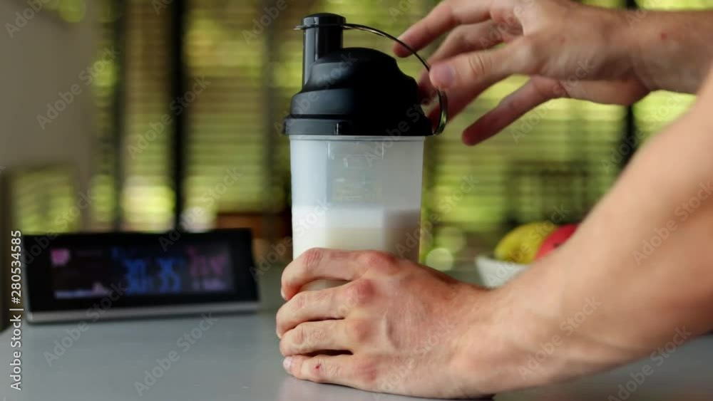 Close-up of a shaker cap getting screwed on a protein shaker. Close-up of a shaker cap getting screwed on a protein shaker.