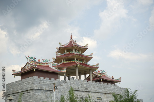 a large Buddhist monastery and huge pagoda and ornaments typical of China with bamboo as a framming foreground located on Tanjung Pinang, Riau Islands