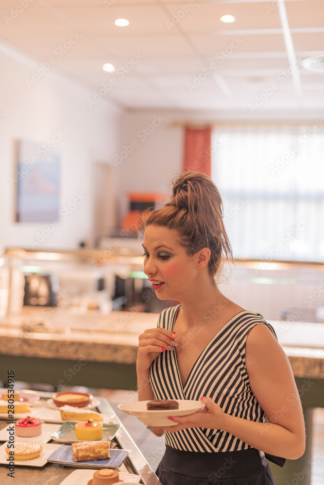 Beautiful and elegant white girl in a food buffet - Delicious desserts