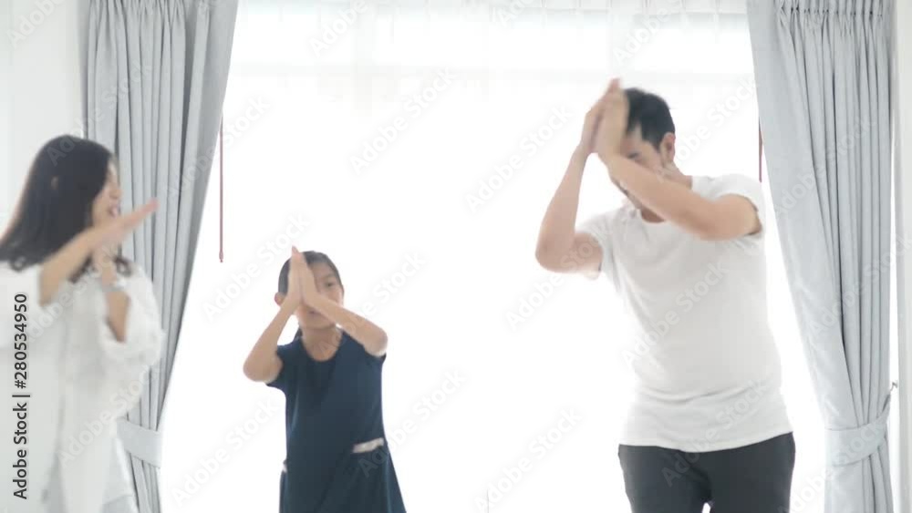 Happy young Asian family dancing together at home. Happy young Asian family dancing together at home.