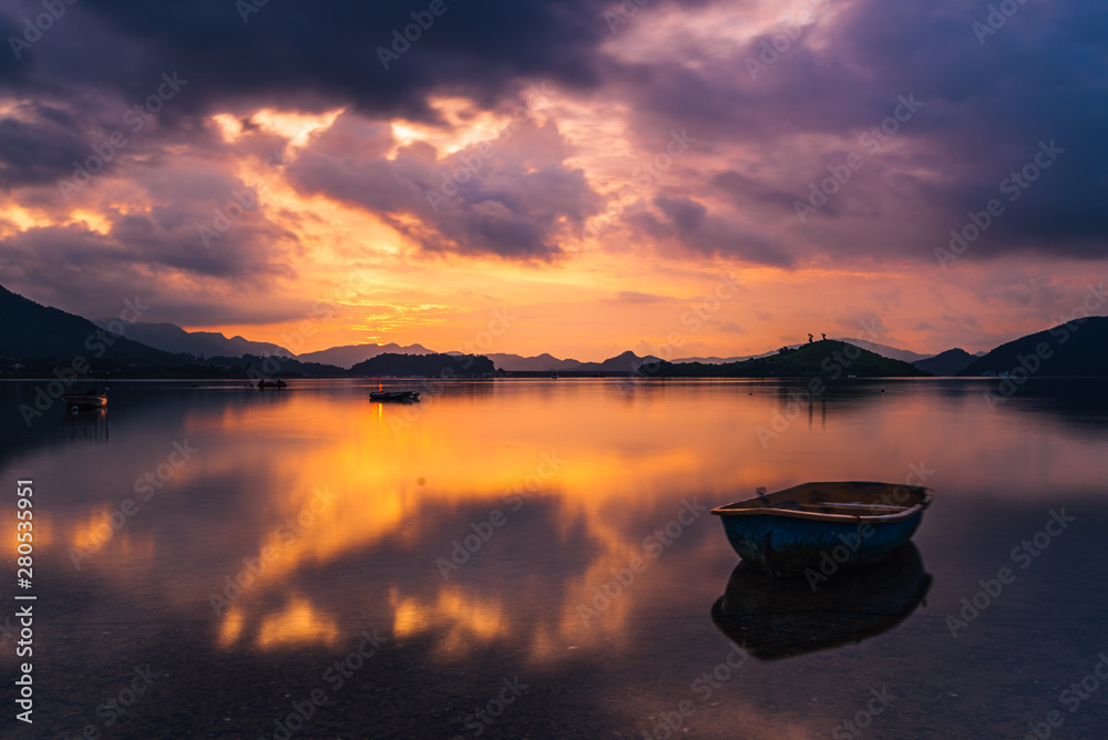 Sunrise with boat and water reflection Sunrise with boat and water reflection