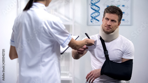 Doctor giving bill to patient in arm sling and foam collar  expensive treatment