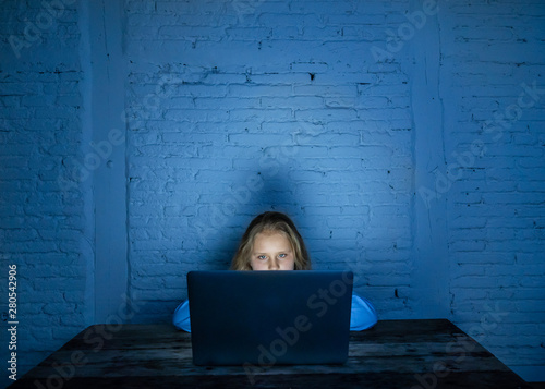 Quadro em tela Sad young girl with laptop suffering bullying and harassment online