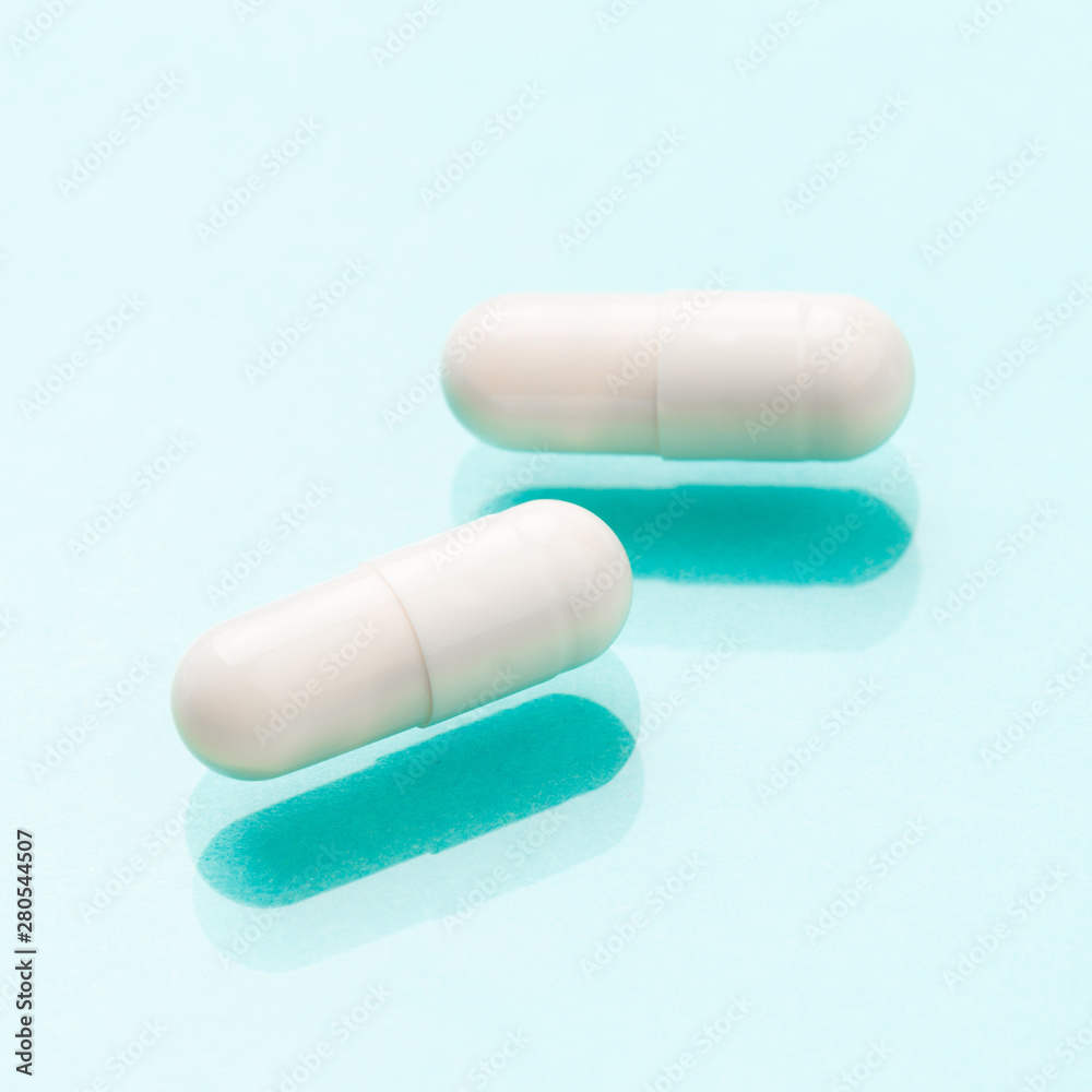 White medicine capsules probiotic powder inside. Close up. High resolution product. Health care concept - Image