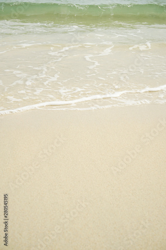 Tropical beach with white coral sand and calm wave with space for text background 