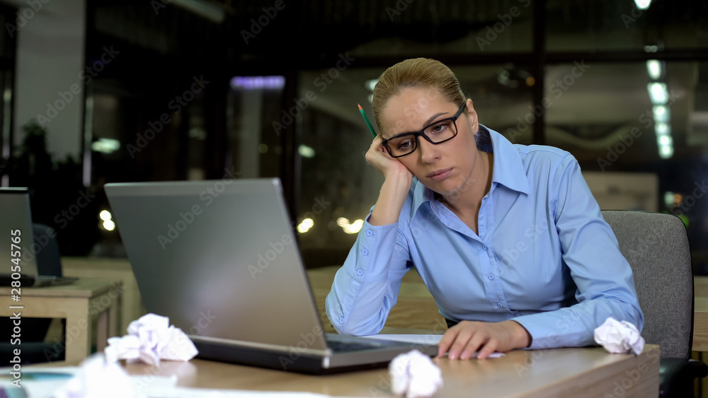 Exhausted woman lacking business ideas, working extra hours in office, burnout