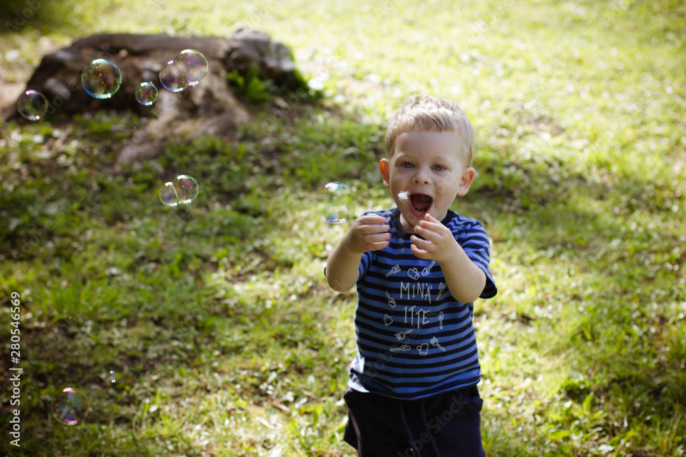 little boy blowing soap bubbles little boy blowing soap bubbles
