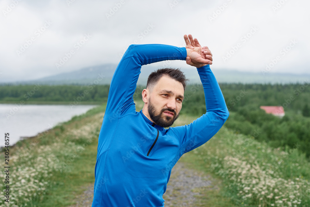 Man exercising outdoor on gloomy day Man exercising outdoor on gloomy day
