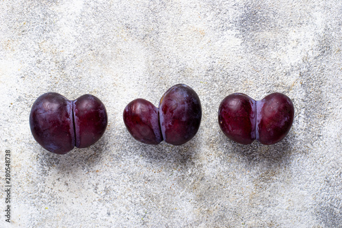 Vászonkép Ugly plums. Abnormal organic fruit