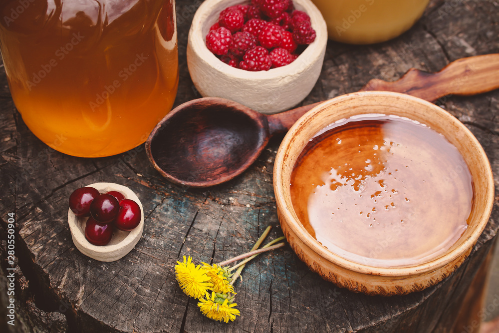 berries and honey in a beautiful dish on a wooden table berries and honey in a beautiful dish on a wooden table