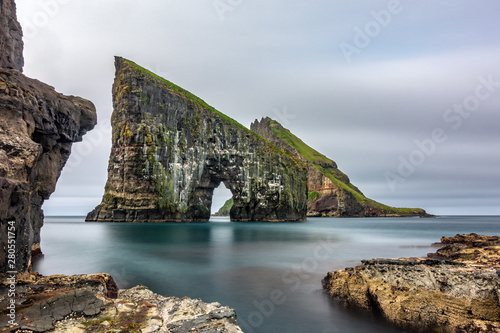 Long exposure of Drangarnir gate in front of Tindholmur, Faroe Islands photo