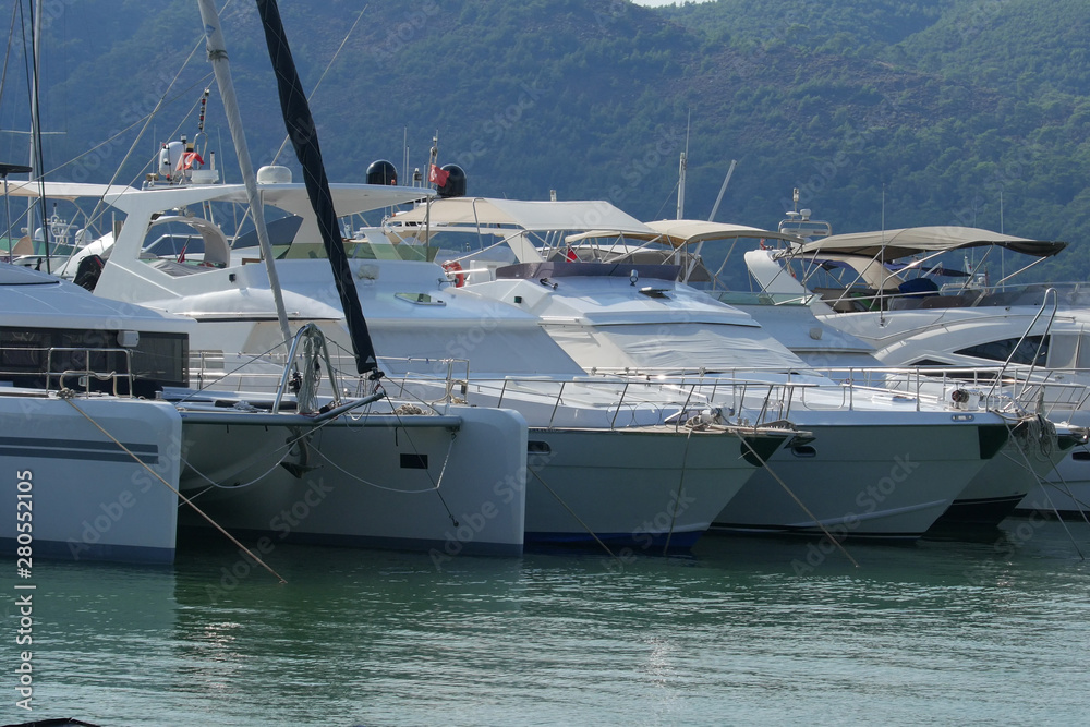 Yachts and boats at the pier in the marina Fethiye, Mugla, Turkey. Yachts and boats at the pier in the marina Fethiye, Mugla, Turkey.