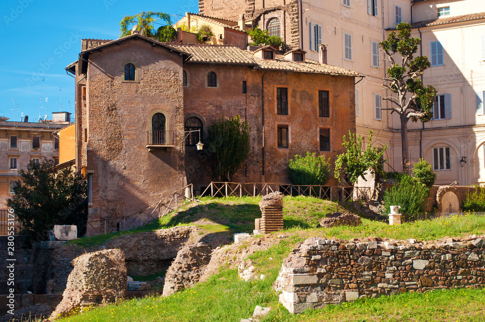 View of many stones, ruins and coay brown house in old town of Rome