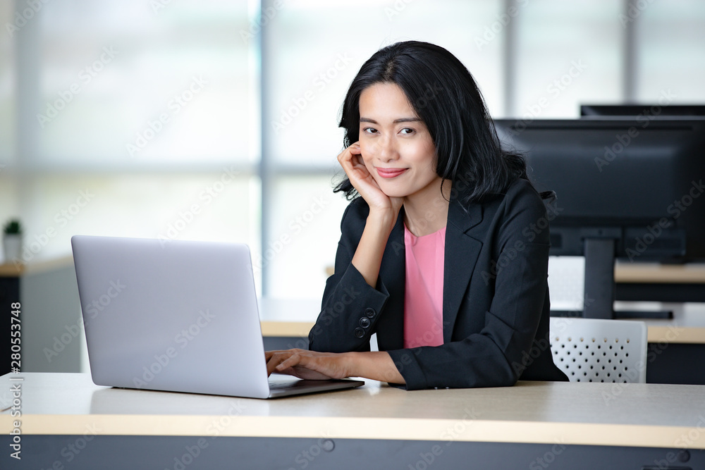 Asian businesswoman using notebook computer.. Asian businesswoman using notebook computer..