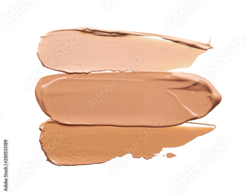 Gently beige strokes and texture of face highlighter or acrylic paint isolated on white background photo