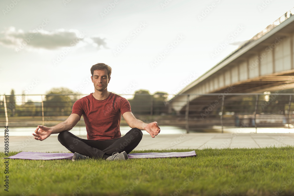 Doing yoga on a sunny summer day in the park