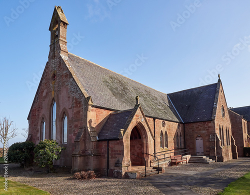 Billede på lærred Colliston Parish Church, built in 1870 by the Victorians stands next to its Old Manse at the end of the Village on the A933 Road near Arbroath, Angus in Scotland