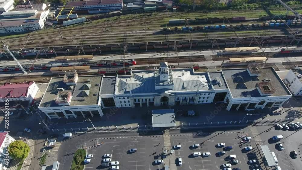 Aerial: central railway station Krasnodar in city center, passenger trains are on the platform, residential buildings, railway in city Krasnodar Russia. Top view from above train 4k. Aerial: central railway station Krasnodar in city center, passenger trains are on the platform, residential buildings, railway in city Krasnodar Russia. Top view from above train 4k.