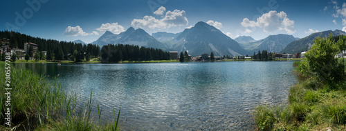 panorama landscape view of the lake and town of Arosa in the Swiss Alps photo