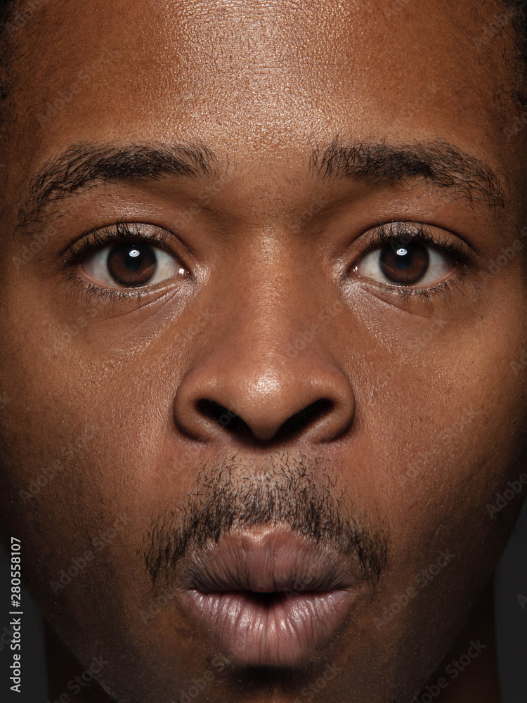 Close up portrait of young and emotional african-american man. Highly detail photoshot of male model with well-kept skin and bright facial expression. Concept of human emotions. Astonished, shocked. Close up portrait of young and emotional african-american man. Highly detail photoshot of male model with well-kept skin and bright facial expression. Concept of human emotions. Astonished, shocked.