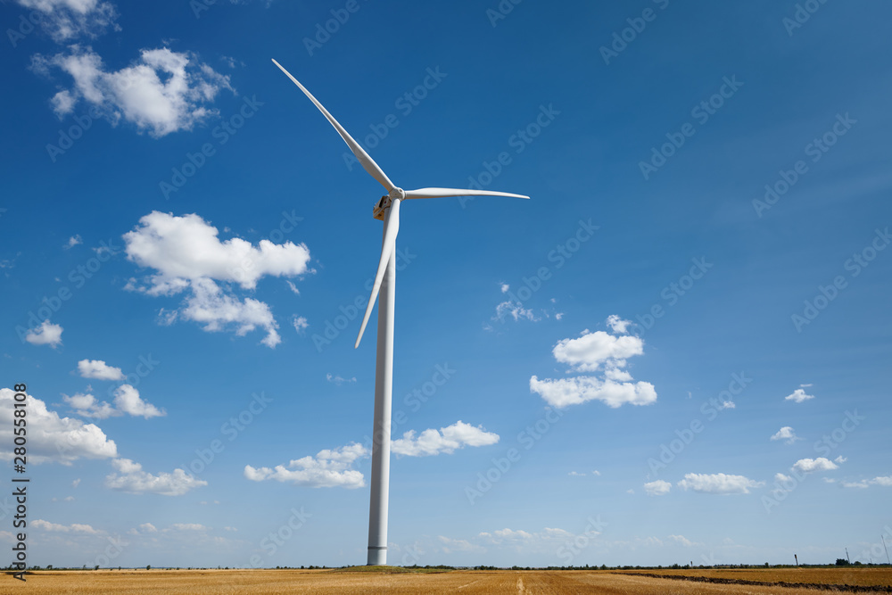wind generator on bright cloudy sky background