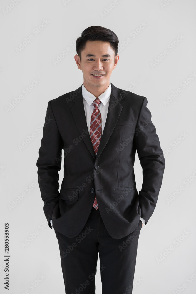 Businessman standing and touchs his tie.. Businessman standing and touchs his tie..