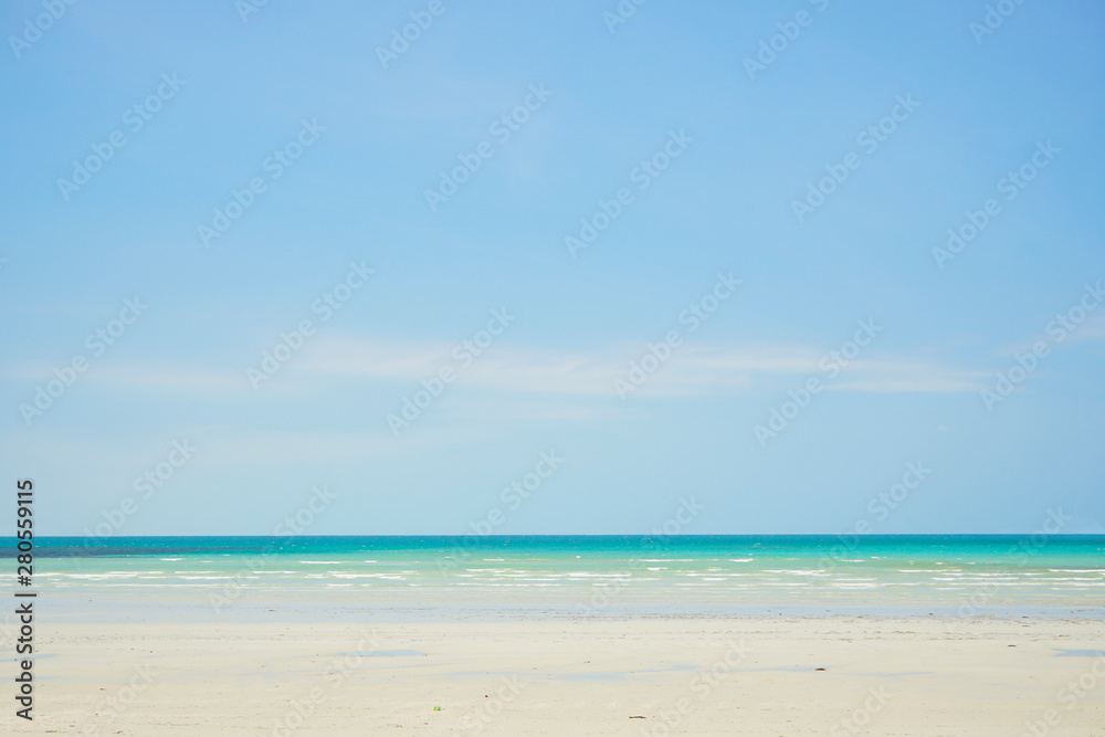 Tropical beach with white coral sand and calm wave with space for text background                   