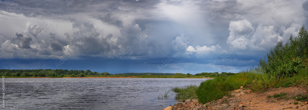 Summer panorama with river and picturesque, cloudy sky Summer panorama with river and picturesque, cloudy sky