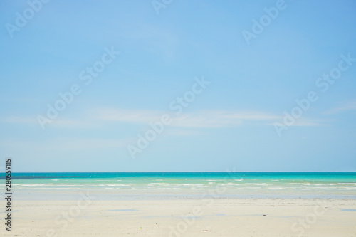 Tropical beach with white coral sand and calm wave with space for text background 