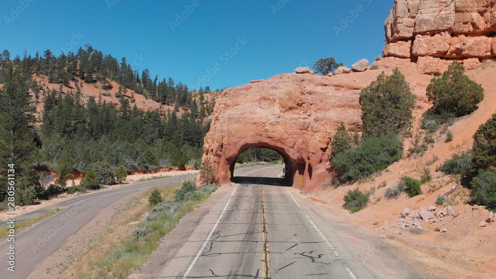 Tunnel entrance of Red Canyon and Bryce Canyon. Red arch located at the entrance of national park Tunnel entrance of Red Canyon and Bryce Canyon. Red arch located at the entrance of national park