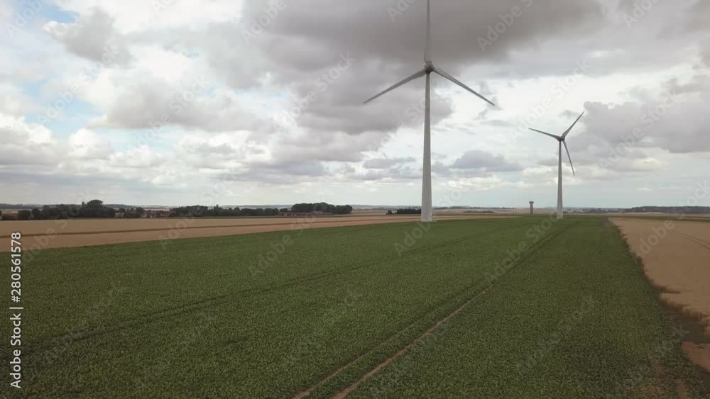 Wind turbines in the countryside in wheat and beet fields. Aerial view 4K drone footage Wind turbines in the countryside in wheat and beet fields. Aerial view 4K drone footage